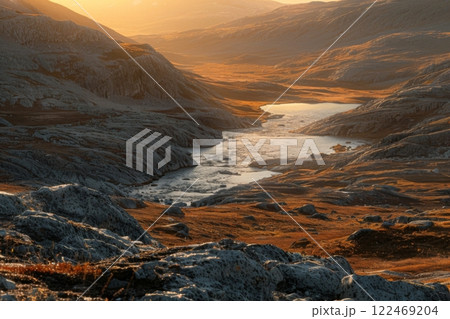Sunset Over Golden Grasslands with Winding River 122469204