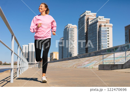Woman jogging running on city embankment with graffiti enjoy outdoor sport activity Woman jogging running on city embankment with graffiti enjoy outdoor sport activity 122470696