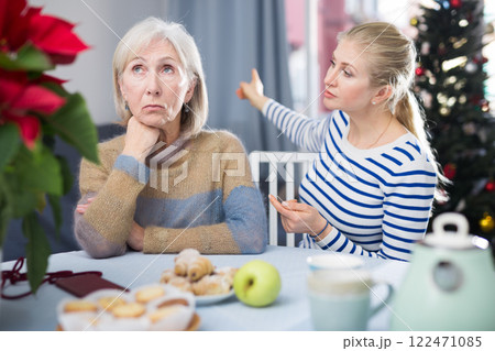 Daughter angry with elderly mother on Christmas night at home 122471085
