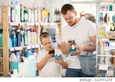 Man and boy scanning qr code for mouthwash Man and boy scanning qr code for mouthwash 122471230