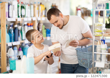 Schoolboy son and dad are choosing mouthwash in store Schoolboy son and dad are choosing mouthwash in store 122471300