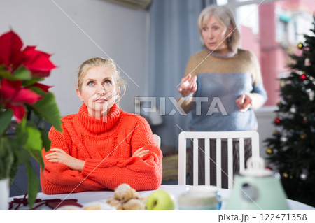 Elderly mother quarreling with daughter during christmas time Elderly mother quarreling with daughter during christmas time 122471358