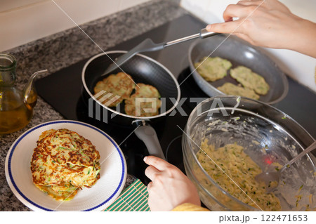 Frying of zucchini fritters Frying of zucchini fritters 122471653