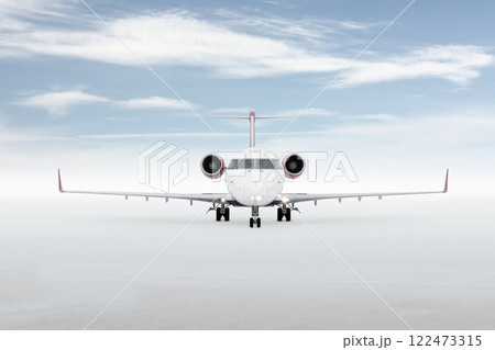 Front view of a passenger regional jet isolated on bright background with sky 122473315