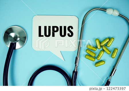 lupus text with stethoscope and capsule medicine on blue background, Healthy and wellness concept lupus text with stethoscope and capsule medicine on blue background, Healthy and wellness concept 122473397