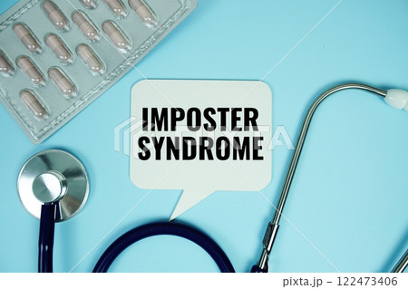 Imposter Syndrome text with stethoscope and capsule medicine on blue background, Healthy and wellness concept 122473406