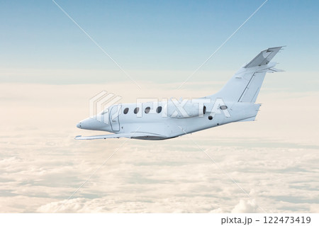 White private jet fly in the air above the clouds 122473419