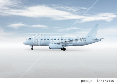White passenger plane isolated on bright background with sky 122473430