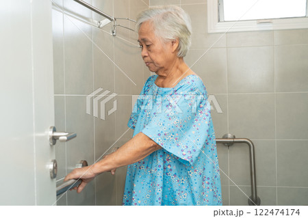 Asian elderly woman patient use toilet bathroom handle security in nursing hospital, healthy strong medical concept. 122474174