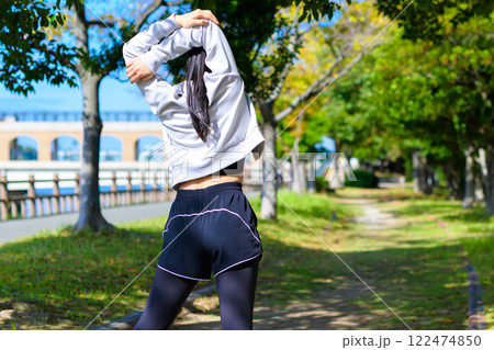 肩甲骨ストレッチ 木漏れ日の道で肩のストレッチをするかっこいい女性 ダイエット トリミングアップ 肩甲骨ストレッチ 木漏れ日の道で肩のストレッチをするかっこいい女性 ダイエット トリミングアップ 122474850