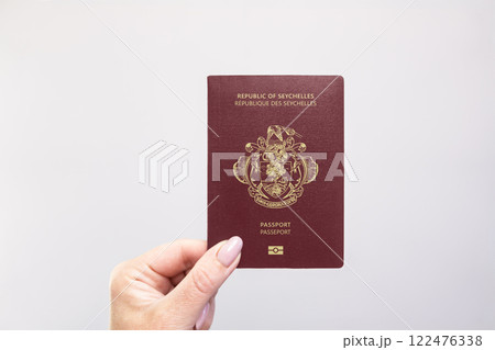 Passport Seychelles Held Against Simple White Background. Astana, Kazakhstan, 26 october 2024 Passport Seychelles Held Against Simple White Background. Astana, Kazakhstan, 26 october 2024 122476338