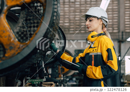 professional engineer caucasian women inspecting auditing old machine in heavy industry factory professional engineer caucasian women inspecting auditing old machine in heavy industry factory 122478126