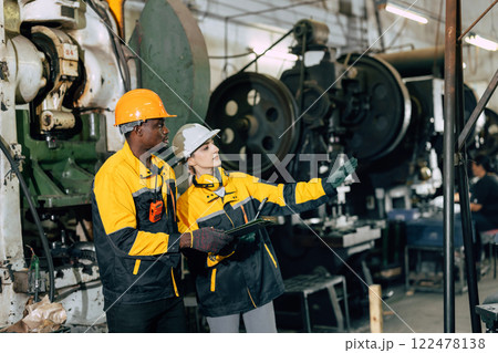 professional engineer team inspecting service machine in heavy industry factory 122478138