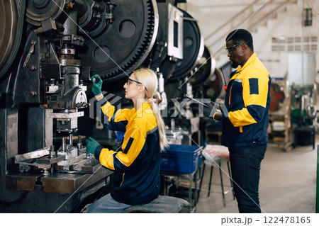 caucasian women worker working in heavy metal industry factory punching stamping steel machine caucasian women worker working in heavy metal industry factory punching stamping steel machine 122478165