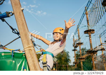 Happy little girl child having fun time at open air rope park Happy little girl child having fun time at open air rope park 122478429