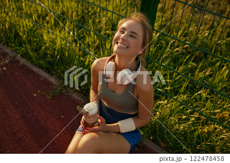 Relaxed woman basketball player having rest Relaxed woman basketball player having rest 122478458