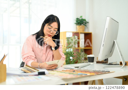 Female designer focused on selecting colors and materials home renovation project 122478890