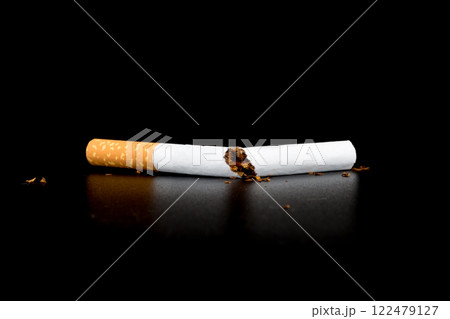 Cigarette butts isolated on black background 122479127