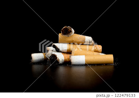 Cigarette butts isolated on black background Cigarette butts isolated on black background 122479133