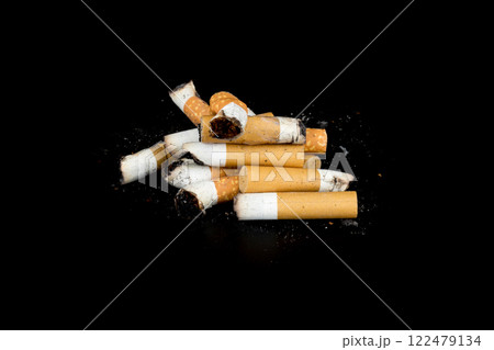 Cigarette butts isolated on black background Cigarette butts isolated on black background 122479134