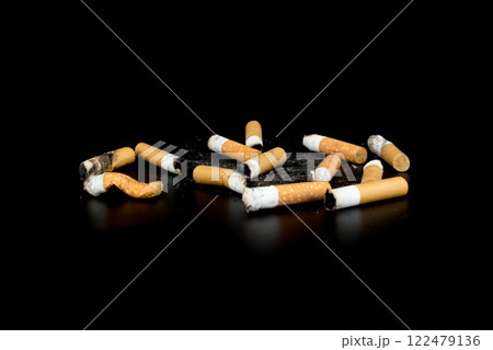 Cigarette butts isolated on black background 122479136