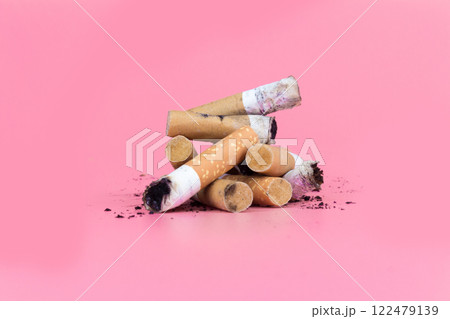 Cigarette butts isolated on pink background 122479139