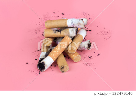 Cigarette butts isolated on pink background Cigarette butts isolated on pink background 122479140
