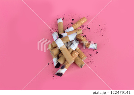 Cigarette butts isolated on pink background Cigarette butts isolated on pink background 122479141