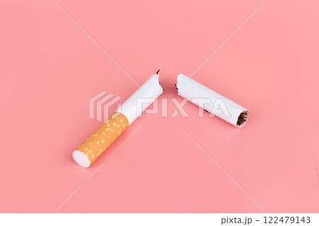 Cigarette butts isolated on pink background Cigarette butts isolated on pink background 122479143