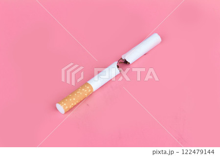 Cigarette butts isolated on pink background Cigarette butts isolated on pink background 122479144