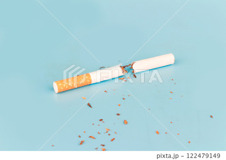 Cigarette butts isolated on blue background Cigarette butts isolated on blue background 122479149