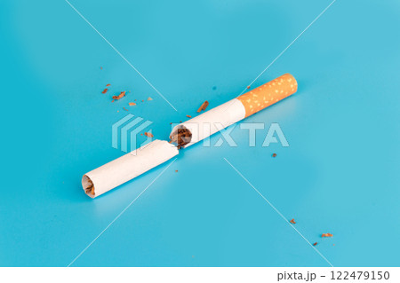 Cigarette butts isolated on blue background Cigarette butts isolated on blue background 122479150