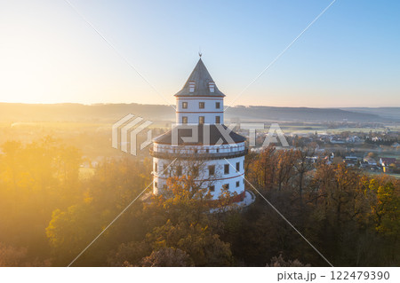 Humprecht chateau rises majestically above Sobotka amidst the tranquil autumn landscape, bathed in the warm glow of sunrise, showcasing its unique elliptical architecture. Humprecht chateau rises majestically above Sobotka amidst the tranquil autumn landscape, bathed in the warm glow of sunrise, showcasing its unique elliptical architecture. 122479390