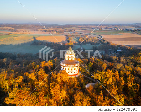 The Baroque Humprecht chateau stands majestically among vibrant autumn foliage, illuminated by a soft sunrise above Sobotka, creating a picturesque scene in the Bohemian Paradise. The Baroque Humprecht chateau stands majestically among vibrant autumn foliage, illuminated by a soft sunrise above Sobotka, creating a picturesque scene in the Bohemian Paradise. 122479393
