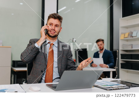 Businessman talking on the phone giving professional consultation to client. 122479773