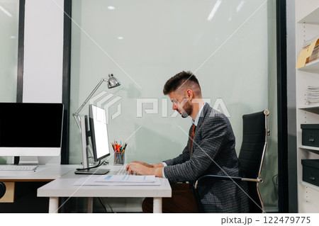 Business man working at office with laptop and documents on desk, financial adviser analyzing data. 122479775