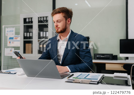 Business man working at office with laptop and documents on desk, financial adviser analyzing data. 122479776