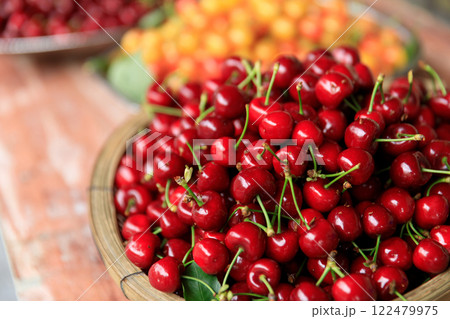 Fesh red cherry fruits in a container Fesh red cherry fruits in a container 122479975