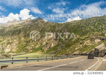A car drives on the Grimsel Pass road in the Swiss Alps, Canton of Bern, Switzerland 122480902