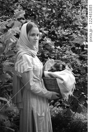 Young girl with basket in the park Young girl with basket in the park 122481885