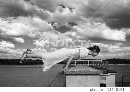 Girl in the city did a horizontal handstand 122481914