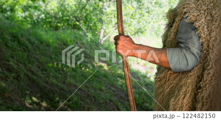 Man's hand with a wooden rod 122482150