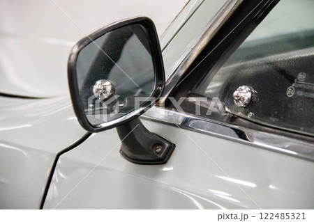 Close up of Classic Car Side Mirror, showcasing the Vintage chrome elements and reflective surface. Automotive retro design projects, gray color of automobile and black elements frame the details Close up of Classic Car Side Mirror, showcasing the Vintage chrome elements and reflective surface. Automotive retro design projects, gray color of automobile and black elements frame the details 122485321