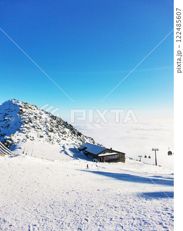 Ski resort. Mountain peak in the clouds Ski resort. Mountain peak in the clouds 122485607