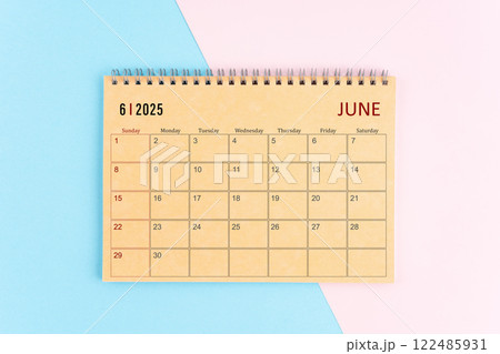 June 2025 craft brown paper calendar on pink and blue background. June 2025 craft brown paper calendar on pink and blue background. 122485931