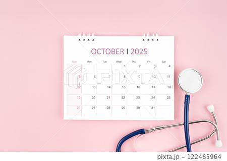 October 2025 desk calendar and stethoscope, Medical appointment concept. October 2025 desk calendar and stethoscope, Medical appointment concept. 122485964