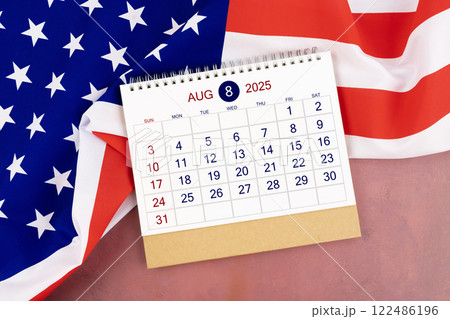 August 2025 Monthly desk calendar and United States of America flag. August 2025 Monthly desk calendar and United States of America flag. 122486196
