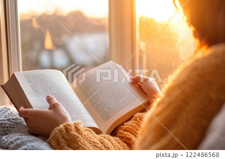 Cozy Sunday Morning with a Person Reading a Book Cozy Sunday Morning with a Person Reading a Book 122486568