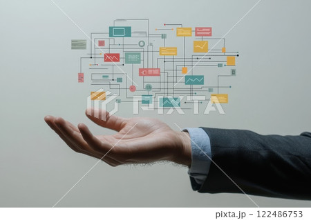 Hand Reaching Out with Digital Flowchart Displaying Interconnected Strategy Elements Hand Reaching Out with Digital Flowchart Displaying Interconnected Strategy Elements 122486753