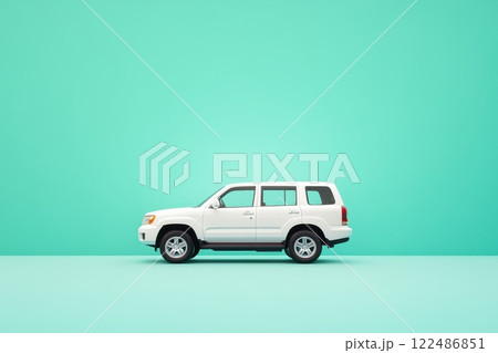 A white car is parked in front of a green wall A white car is parked in front of a green wall 122486851